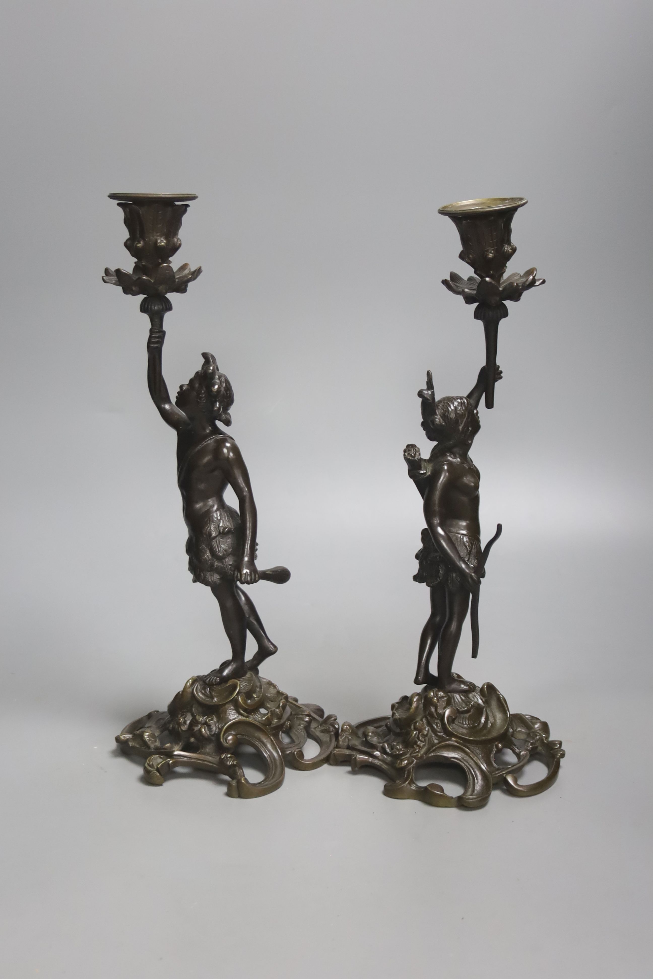 A pair of 19th century French bronze candlesticks, modelled as natives, height 32cm